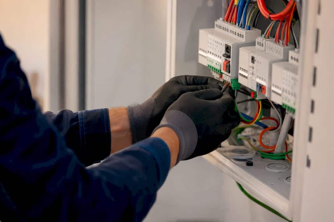 Hände verkabeln eine Smart-Home-Steuerbox